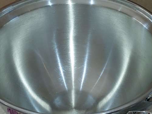 A VINTAGE STAINLESS STEEL SOUP TURINE WITH A LADEL
