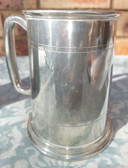 TWO BEER MUGS A SILVER PLATED AND A PEWTER MUG SOLD AS IS