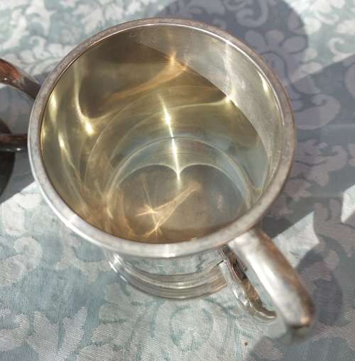 TWO BEER MUGS A SILVER PLATED AND A PEWTER MUG SOLD AS IS