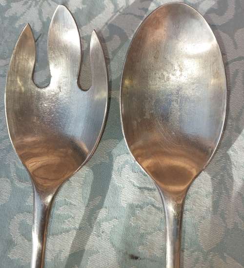 A CLASSIC DESIGNED PAIR OF SALAD TONGS SOLD AS IS