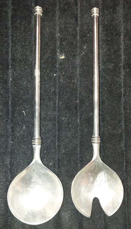 A  pair of stainless steel salad ladles sold as is