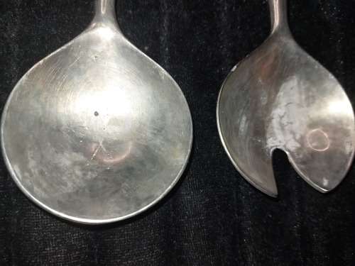 A  pair of stainless steel salad ladles sold as is