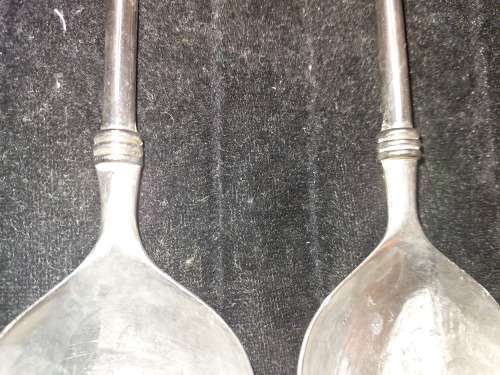 A  pair of stainless steel salad ladles sold as is