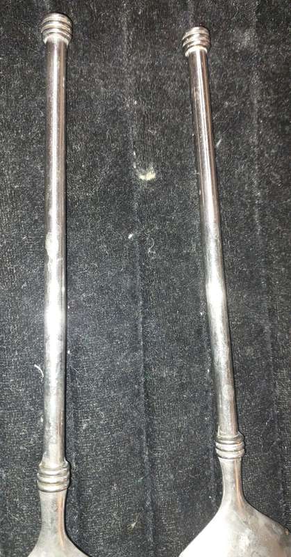 A  pair of stainless steel salad ladles sold as is