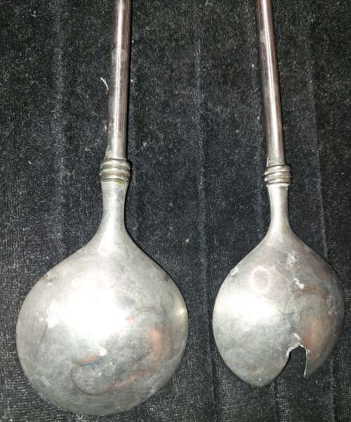 A  pair of stainless steel salad ladles sold as is