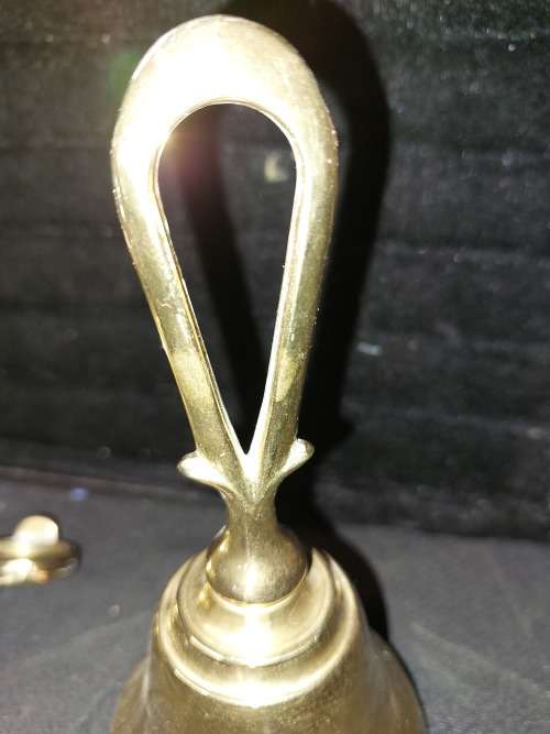 A SOLID HEAVY BRASS CANDLE STAND AND SOLID BRASS BELL