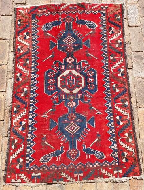 A VINTAGE MULTI-COLOURED PERSIAN RUG
