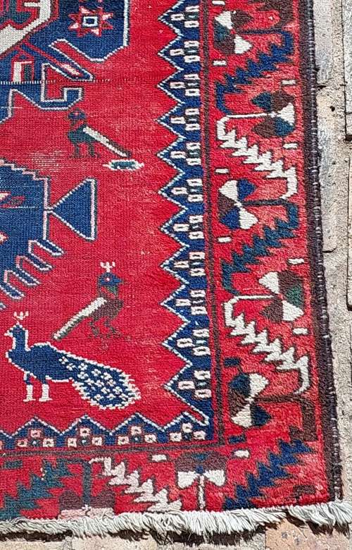 A VINTAGE MULTI-COLOURED PERSIAN RUG