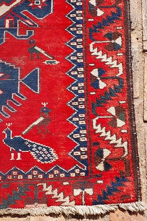 A VINTAGE MULTI-COLOURED PERSIAN RUG