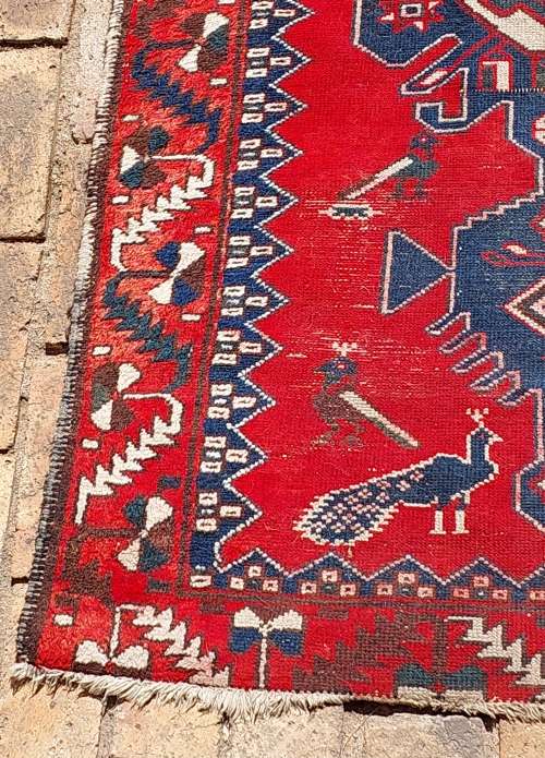 A VINTAGE MULTI-COLOURED PERSIAN RUG
