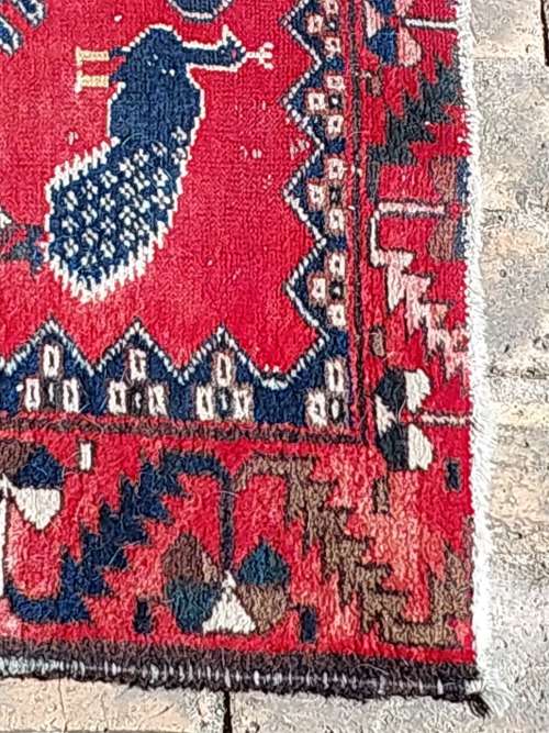 A VINTAGE MULTI-COLOURED PERSIAN RUG