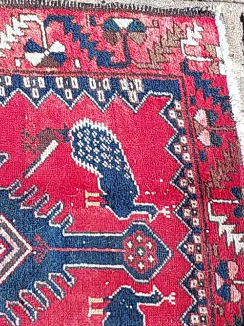 A VINTAGE MULTI-COLOURED PERSIAN RUG