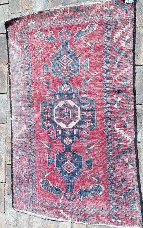 A VINTAGE MULTI-COLOURED PERSIAN RUG