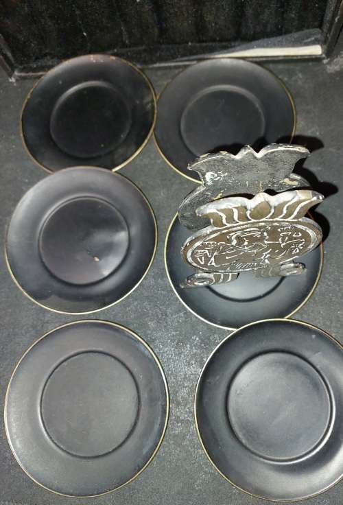 A VINTAGE SET EGYPTIAN PHAROAH BLACK ON BRASS COASTERS