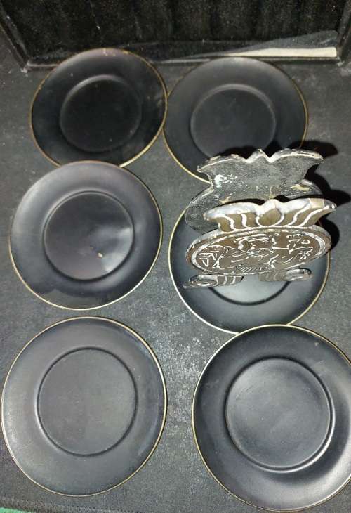 A VINTAGE SET EGYPTIAN PHAROAH BLACK ON BRASS COASTERS