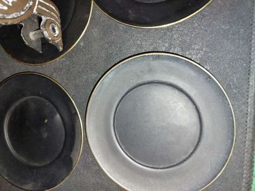 A VINTAGE SET EGYPTIAN PHAROAH BLACK ON BRASS COASTERS