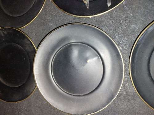 A VINTAGE SET EGYPTIAN PHAROAH BLACK ON BRASS COASTERS