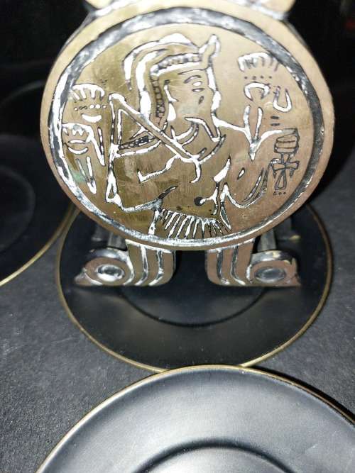 A VINTAGE SET EGYPTIAN PHAROAH BLACK ON BRASS COASTERS