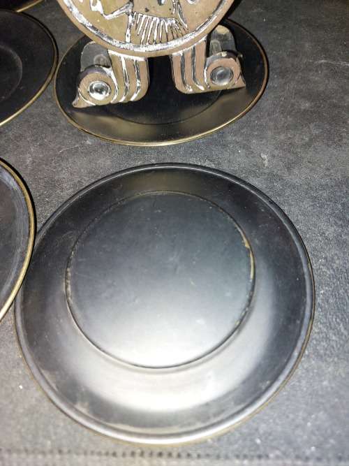 A VINTAGE SET EGYPTIAN PHAROAH BLACK ON BRASS COASTERS