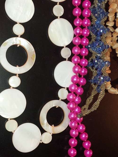 A COLLECTION OF SYNTHETIC BEAD COSTUME NECKLACES