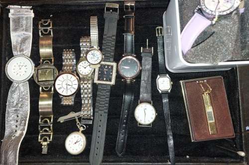 A COLLECTION OF DESIGNER DRESS WATCHES SOLD AS IS NOT TESTED