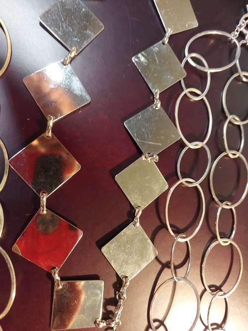 A COLLECTION OF FASHION CHAIN BELTS SOLD AS IS