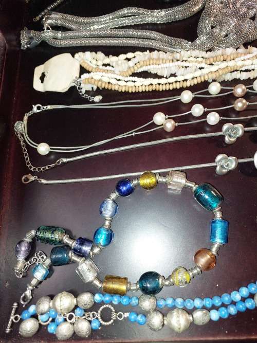 A VINTAGE COLLECTION OF COSTUME JEWELRY SOLD AS IS