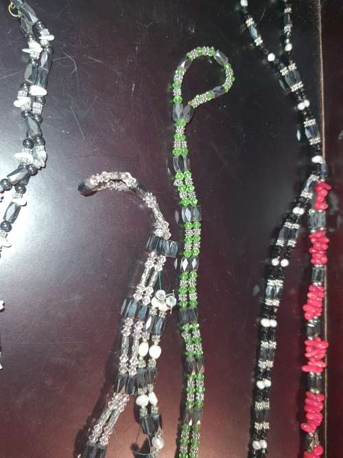 A COLLECTION OF MEGNATIC COSTUME NECKLACES SOLD AS IS
