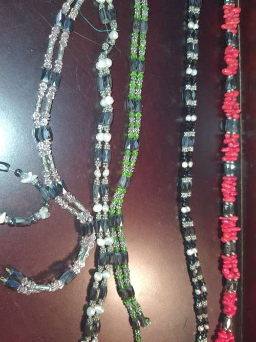 A COLLECTION OF MEGNATIC COSTUME NECKLACES SOLD AS IS