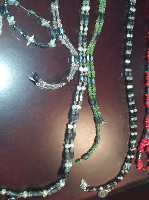 A COLLECTION OF MEGNATIC COSTUME NECKLACES SOLD AS IS