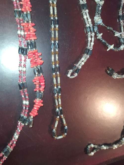 A COLLECTION OF MEGNATIC COSTUME NECKLACES SOLD AS IS