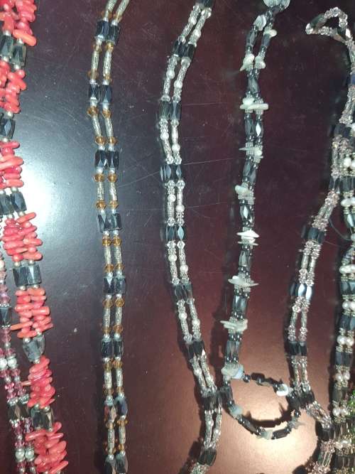 A COLLECTION OF MEGNATIC COSTUME NECKLACES SOLD AS IS