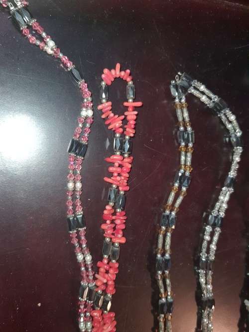 A COLLECTION OF MEGNATIC COSTUME NECKLACES SOLD AS IS