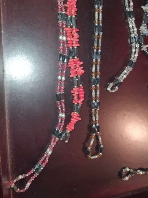A COLLECTION OF MEGNATIC COSTUME NECKLACES SOLD AS IS