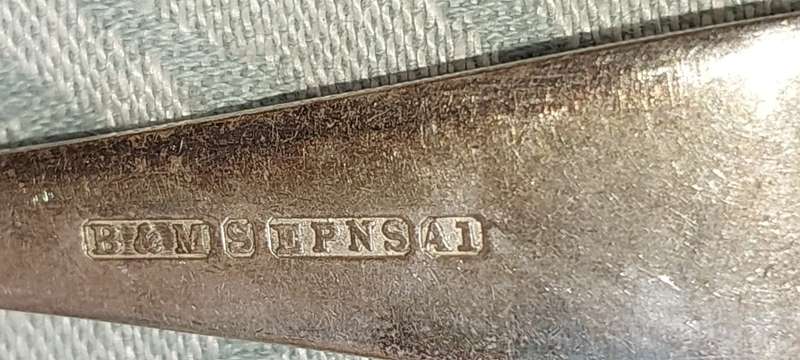 AN ANTIQUE SET OF TABLE FORKS SOLD AS IS