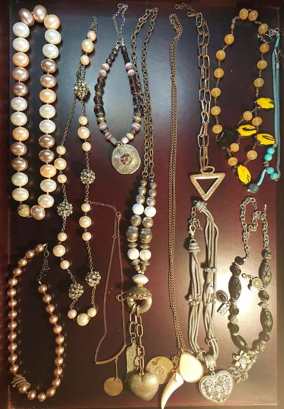 A VINTAGE COLLECTION OF COSTUME NECKLACES SOLD AS IS