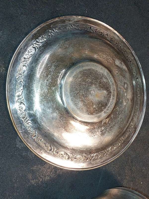 A VINTAGE SILVER PLATED TEA CUP AND SAUCER
