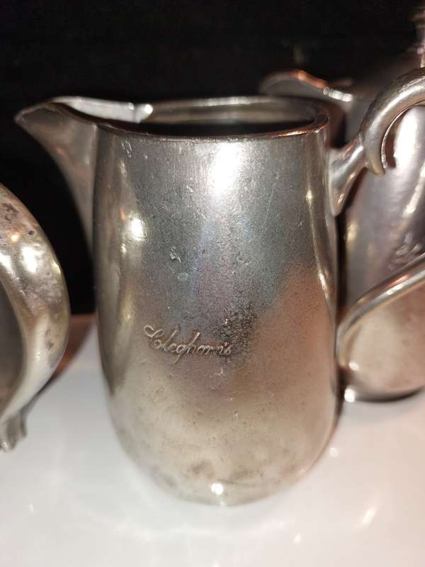 A VICTORIAN SET OF THREE ELKINGTON PLATE CLEGHORNS TEA POTS AND MILK JUG