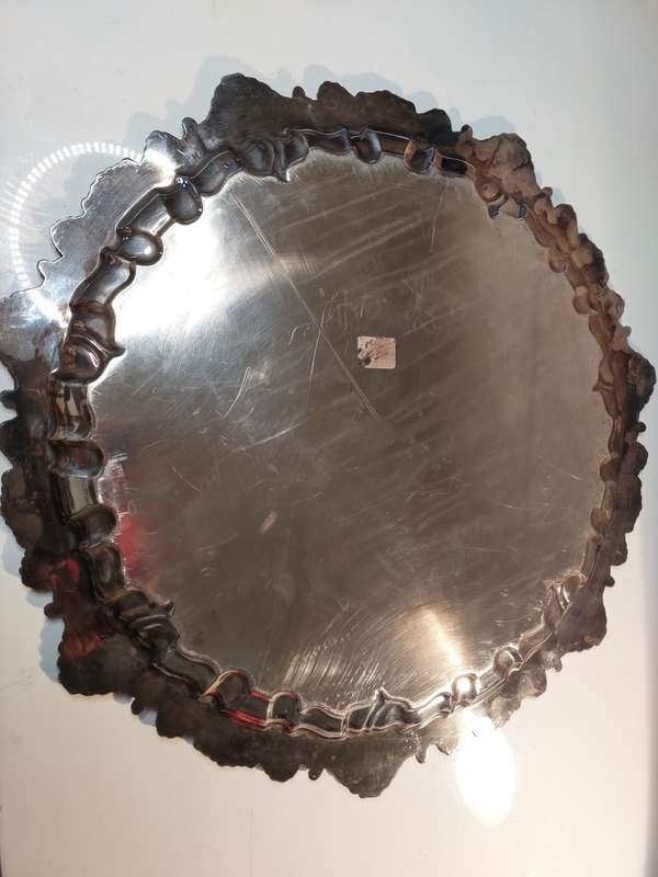 A VINTAGE 43 TO 44-CENTIMETER VICTORIAN SILVER PLATED WITH ORNATE DESIGNS SERVING TRAY
