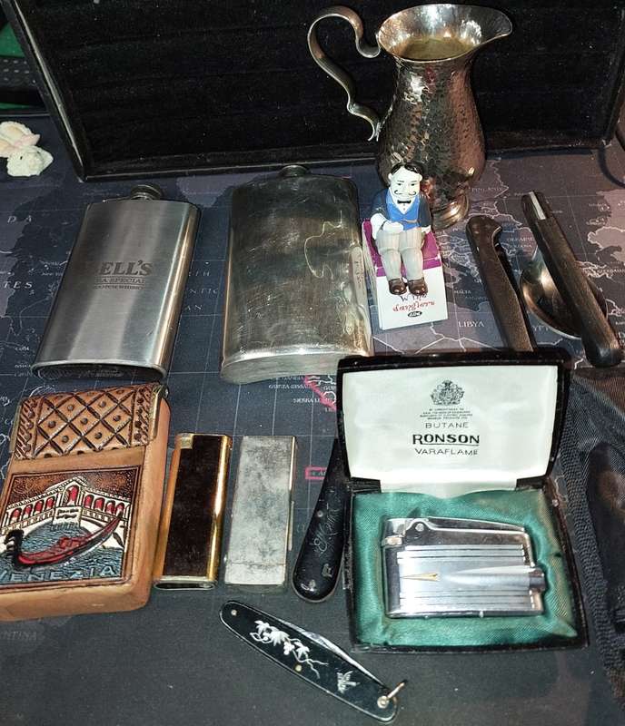 A COLLECTION OF FLASKS CIGARETTE LIGHTERS  POCKET KNIVES AND A LEATHER CIGARETTE HOLDER SOLD AS IS