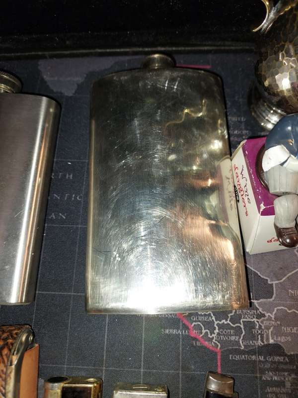 A COLLECTION OF FLASKS CIGARETTE LIGHTERS  POCKET KNIVES AND A LEATHER CIGARETTE HOLDER SOLD AS IS