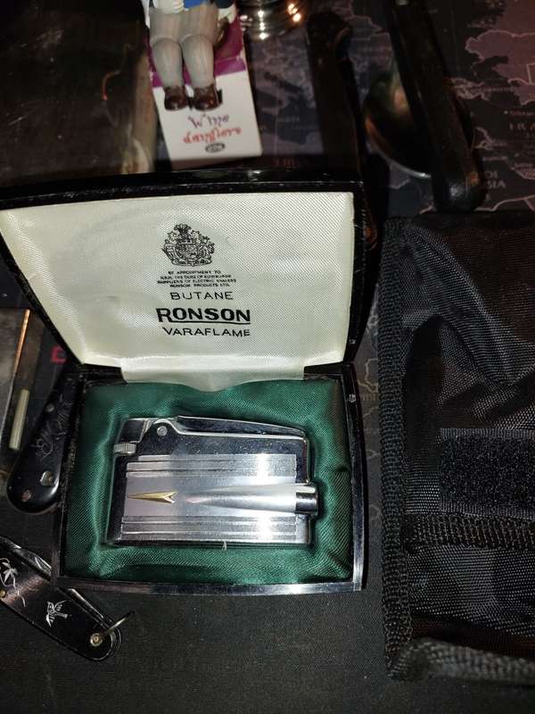 A COLLECTION OF FLASKS CIGARETTE LIGHTERS  POCKET KNIVES AND A LEATHER CIGARETTE HOLDER SOLD AS IS