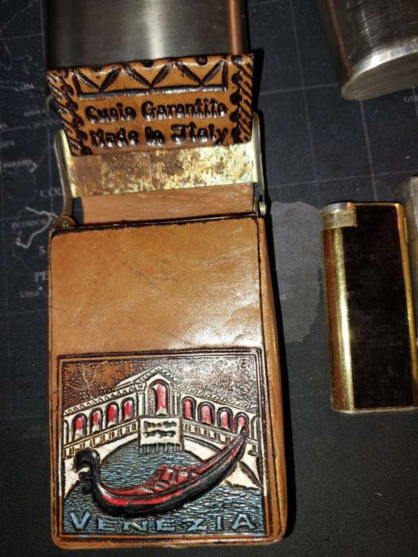 A COLLECTION OF FLASKS CIGARETTE LIGHTERS  POCKET KNIVES AND A LEATHER CIGARETTE HOLDER SOLD AS IS
