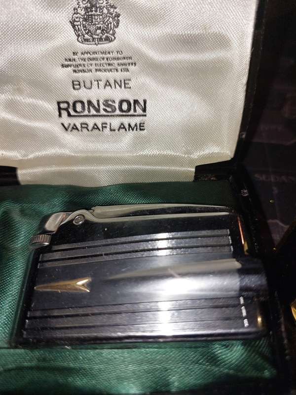 A COLLECTION OF FLASKS CIGARETTE LIGHTERS  POCKET KNIVES AND A LEATHER CIGARETTE HOLDER SOLD AS IS