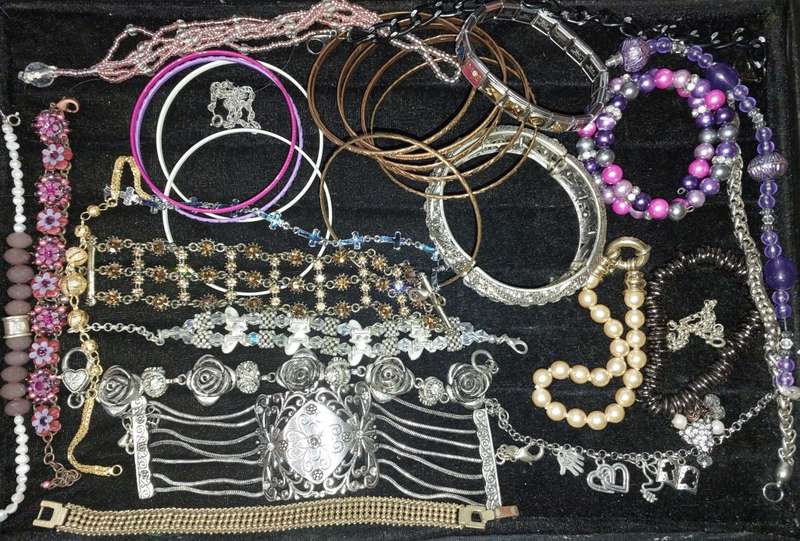 A BULK VINTAGE COLLECTION OF BRACELETS AND BANGLES SOLD AS IS