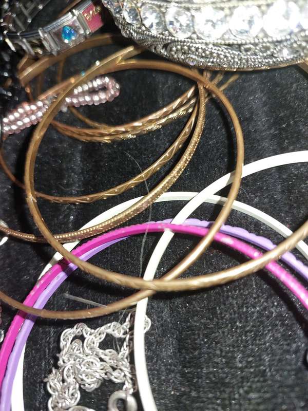 A BULK VINTAGE COLLECTION OF BRACELETS AND BANGLES SOLD AS IS
