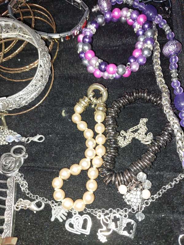 A BULK VINTAGE COLLECTION OF BRACELETS AND BANGLES SOLD AS IS