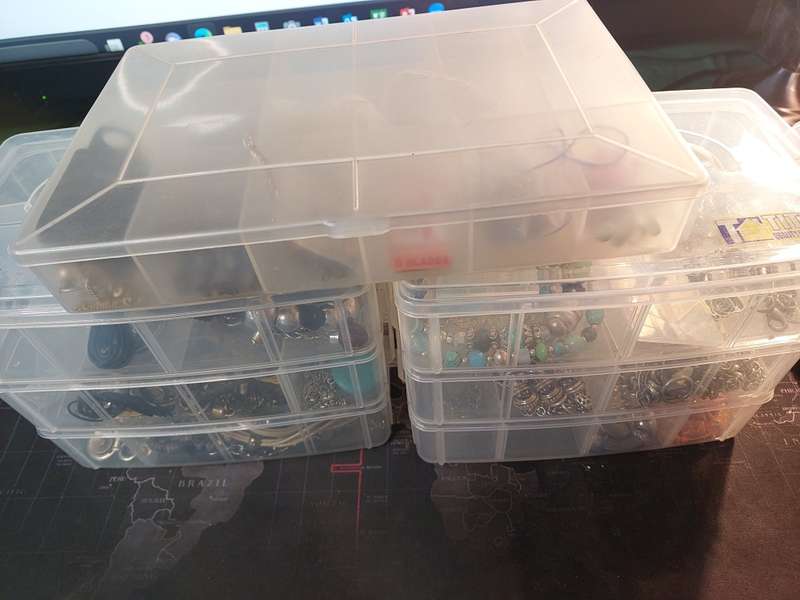 A BULK COLLECTION OF COSTUME JEWELRY AND THE PLASTIC CASES SOLD AS IS