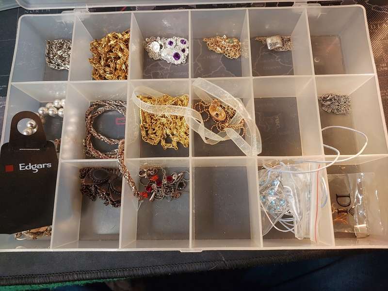 A BULK COLLECTION OF COSTUME JEWELRY AND THE PLASTIC CASES SOLD AS IS