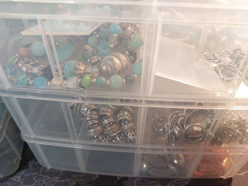 A BULK COLLECTION OF COSTUME JEWELRY AND THE PLASTIC CASES SOLD AS IS